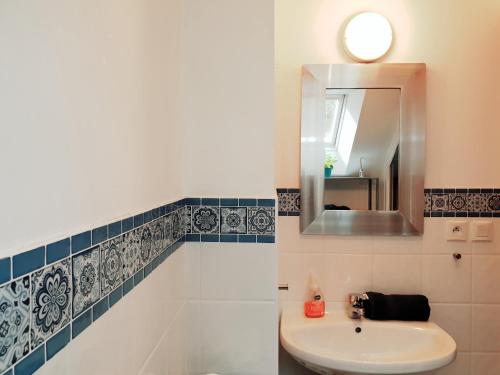 a bathroom with a sink and a mirror at Gite De La Tannerie 2 in Dinan