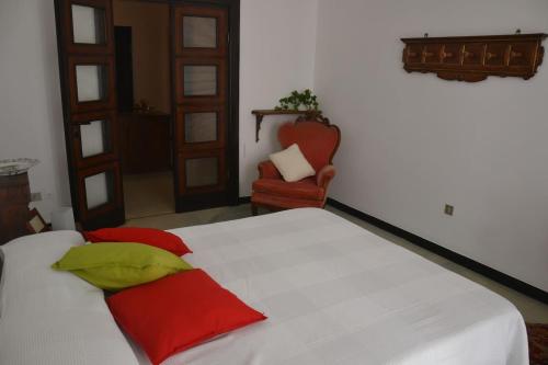 a bedroom with a bed with red and green pillows at Fieschi Inn in Genoa