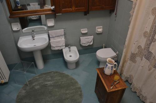 a small bathroom with a sink and a toilet at Fieschi Inn in Genoa