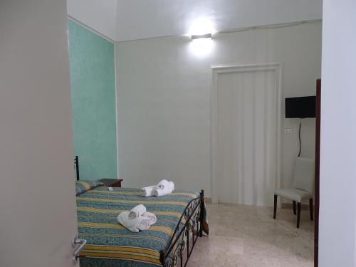 a bedroom with a bed with towels on it at b&b new antico palazzo in Parabita