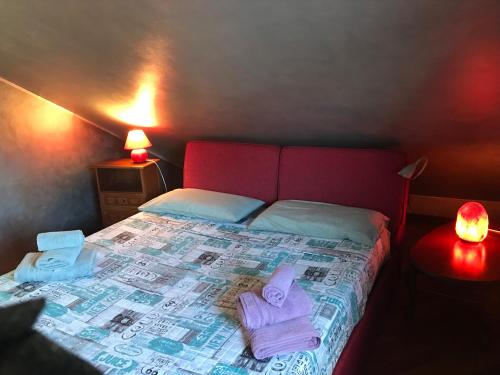 a bedroom with a bed with towels on it at B&B Borgo dei Fiori in Rozzano