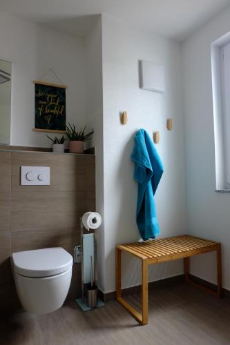 a bathroom with a toilet and a blue towel at Boutique Appartement @Park in Rheinhausen