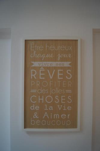 a framed picture on a wall with writing on it at Bonjour Bonheur in Avellino