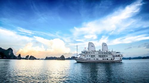 a cruise ship on the water under a cloudy sky at Signature Halong Cruise in Ha Long