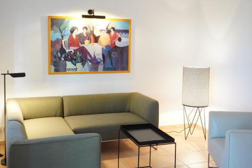 a living room with a couch and a painting on the wall at Ferien in Himmelpfort in Himmelpfort