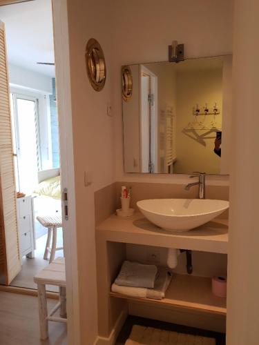 une salle de bain avec un lavabo et un miroir dans l'établissement Entre terre et mer Plein centre Terrasse, à Cassis