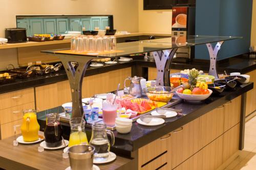 a table with a bunch of food on it in a kitchen at Rio Hotel by Bourbon Curitiba in Curitiba