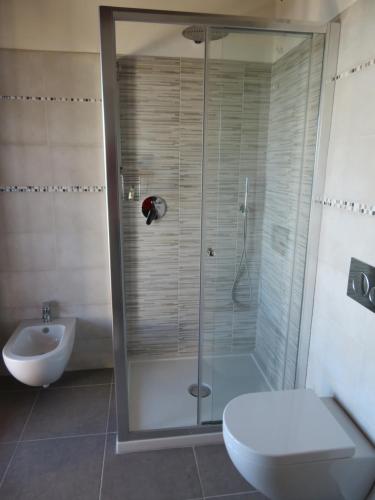 a bathroom with a shower and a toilet and a sink at Il Capanno in Pietra Ligure