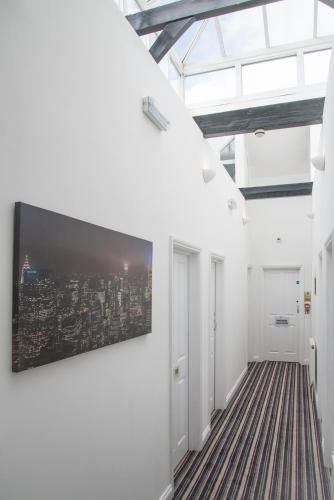 a living room with a large tv on a wall at TLK Apartments & Hotel - Beckenham in Beckenham