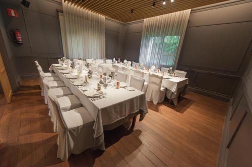 a large conference room with white tables and chairs at Hotel Artaza in Getxo