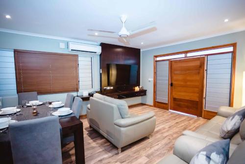 a living room with a couch and a table at Platinum Cawa Apartments in Nadi