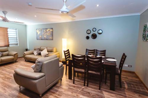a living room with a couch and a table and chairs at Platinum Cawa Apartments in Nadi