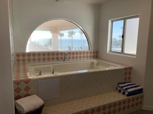 a bath tub in a bathroom with a window at Casa Tropicana in San Clemente