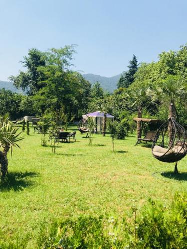 a park with a swing in the grass at Royal Palace Hotel, Lagodekhi in Lagodekhi