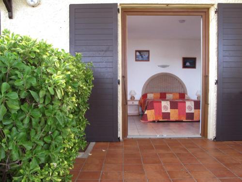 a door leading to a bedroom with a bed at Domaine de Saint Pierre in Cargèse
