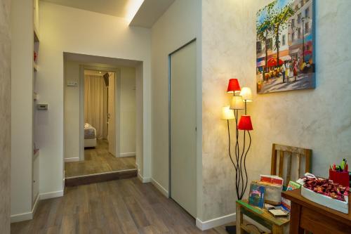 a hallway with a fireplace and a red lamp at Zefiro Home in Rome