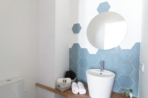a bathroom with a sink and a mirror at Mon hotel in Ciutadella