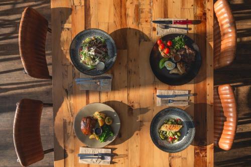 a wooden table with plates of food on it at Novotel Cardiff Centre in Cardiff