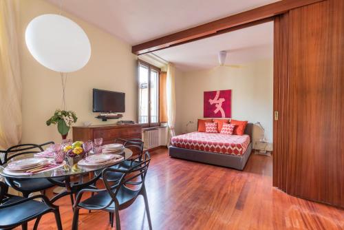 a living room with a table and chairs and a couch at Design Apartments Florence- Florence City Center in Florence