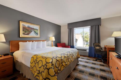 a hotel room with a bed and a window at Baymont by Wyndham Lithia Springs Atlanta in Lithia Springs