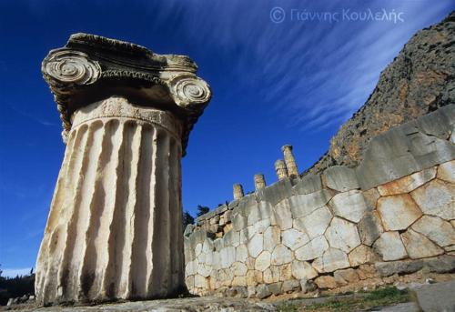 a stone column next to a stone wall at Artemis Hotel in Delfoi