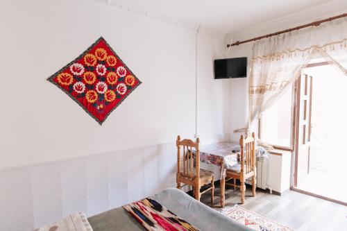 a dining room with a table and a window at Trip.LE Guest house in Samarkand