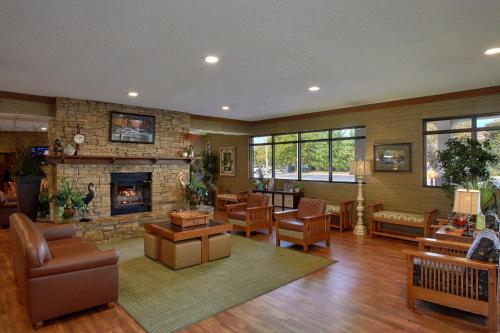a large living room with a stone fireplace at The Inn On The River in Pigeon Forge