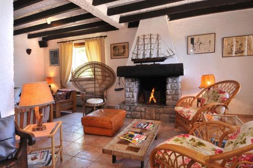 a living room with a fireplace and a couch at Domaine de Saint Pierre in Cargèse