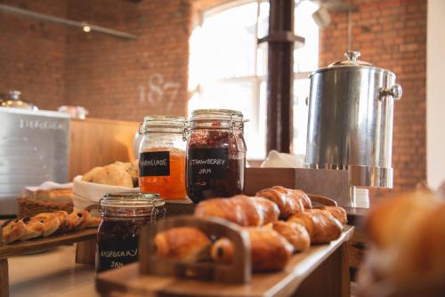 a counter with jars of honey and some pastries at Novotel Cardiff Centre in Cardiff