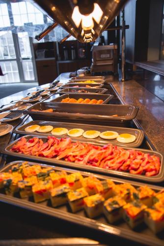 a buffet line with trays of food on display at Novotel Cardiff Centre in Cardiff