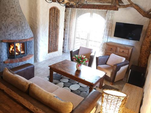 a living room with a couch and a fireplace at Kraina Alkos - Adults Only (18+) in Iznota