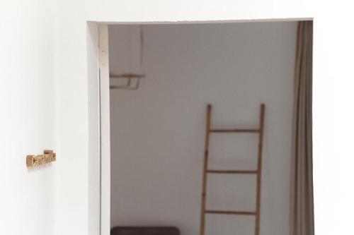 a door leading into a room with a ladder at Mon hotel in Ciutadella