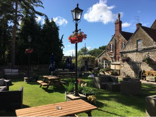 a park with a picnic table and a street light at The Bell at Old Sodbury in Chipping Sodbury