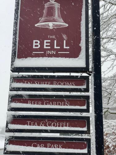 a sign for the bell inn in the snow at The Bell at Old Sodbury in Chipping Sodbury