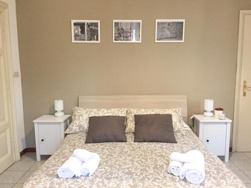 a bedroom with a bed with two towels on it at Domus Santa Caterina in Rome
