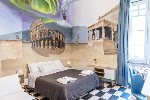 - une chambre avec un lit et une peinture murale dans l'établissement Giro nel mondo, à Catane