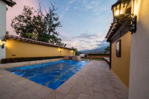 a swimming pool in the backyard of a house at Nueva Granada Hotel Colonial -Centro Histórico- in Santa Fe de Antioquia