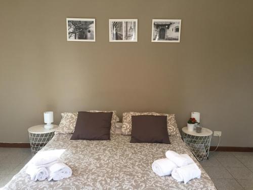 a bedroom with a bed with towels on it at Domus Santa Caterina in Rome