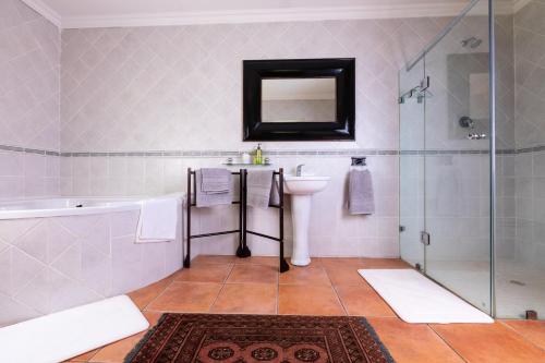 a bathroom with a sink and a shower at Olive Tree Farm in Magaliesburg