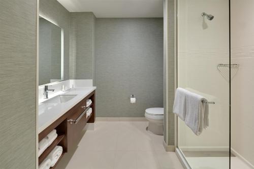 a bathroom with a toilet and a sink and a shower at Residence Inn by Marriott Ontario Rancho Cucamonga in Rancho Cucamonga