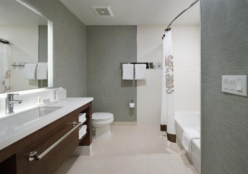 a bathroom with a sink and a toilet and a shower at Residence Inn by Marriott Ontario Rancho Cucamonga in Rancho Cucamonga