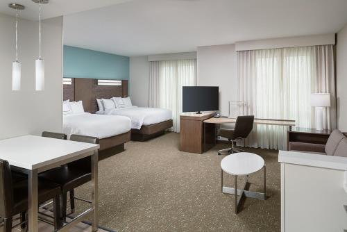 a hotel room with two beds and a television at Residence Inn by Marriott Ontario Rancho Cucamonga in Rancho Cucamonga