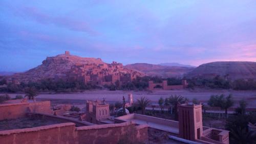 a view of a desert with a mountain in the background at Dar Mouna in Aït Ben Haddou