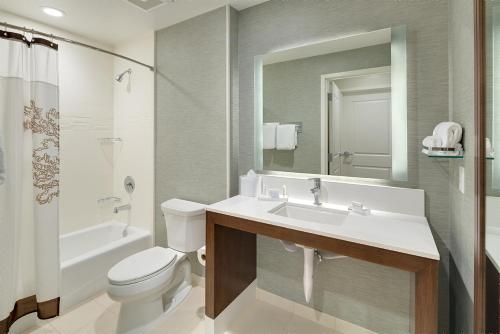 a bathroom with a sink and a toilet and a tub at Residence Inn by Marriott Ontario Rancho Cucamonga in Rancho Cucamonga