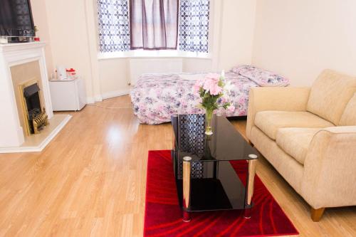 a living room with a couch and a table at QUEEN GUEST HOUSE in Gillingham