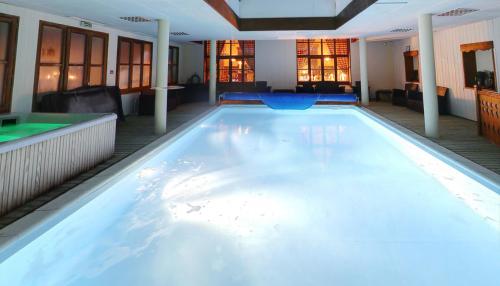 a large swimming pool in a hotel room at Lautaret Lodge & Spa in Le Monêtier-les-Bains