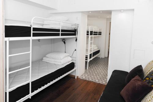 a room with two bunk beds and a couch at City Backpackers Hostel in Stockholm
