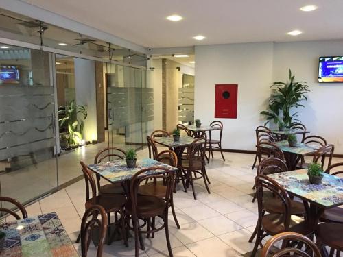 restauracja ze stołami i krzesłami w pokoju w obiekcie Portal da Princesa Hotel w mieście Feira de Santana