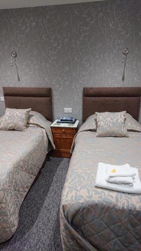 Postel nebo postele na pokoji v ubytování Grove House Hotel