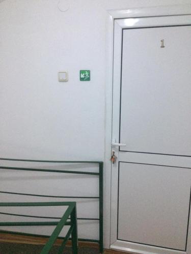 a door with a sign on it in a room at Pensiunea Everest in Craiova